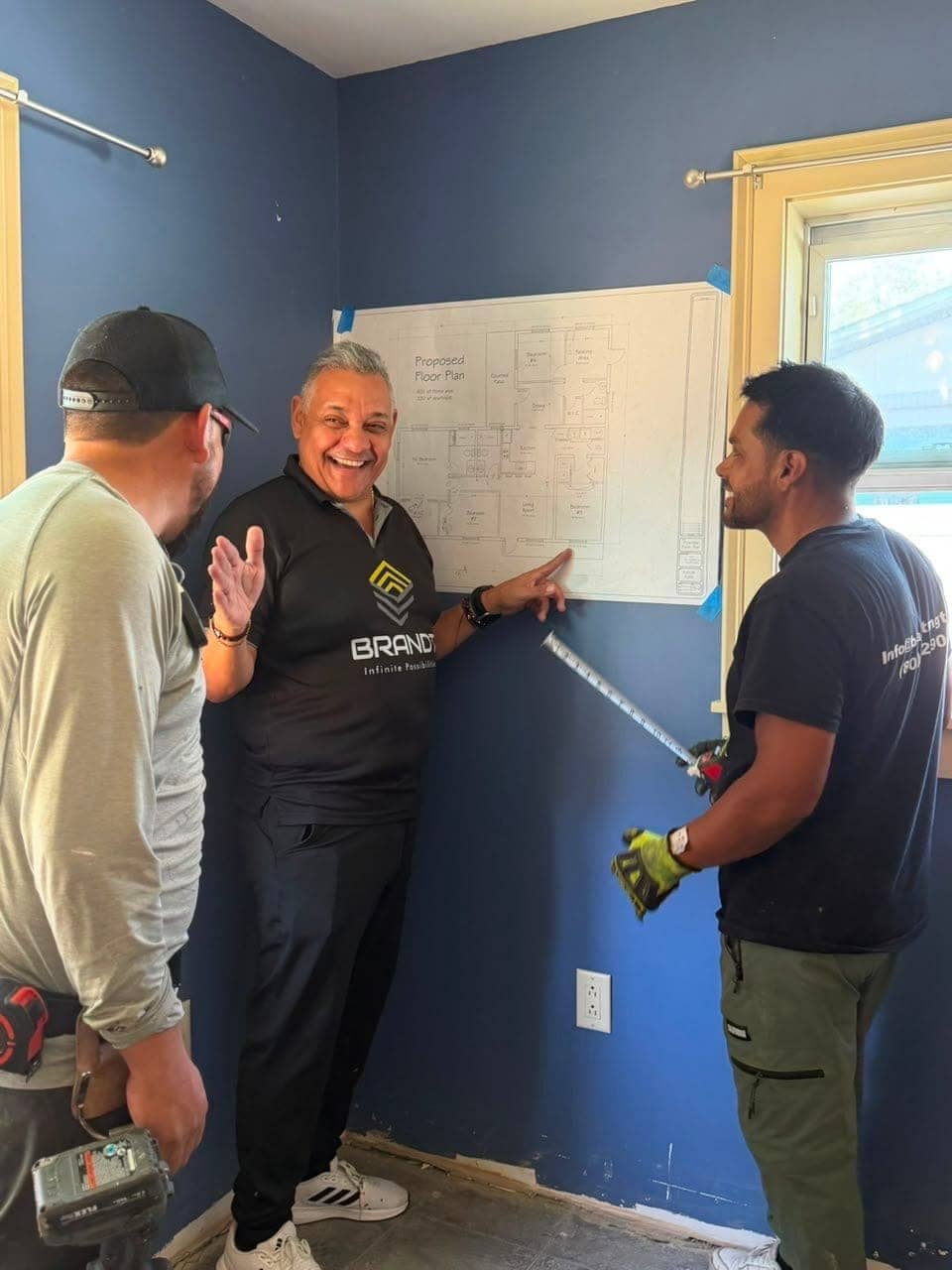Brandt team coordinating around a floor plan