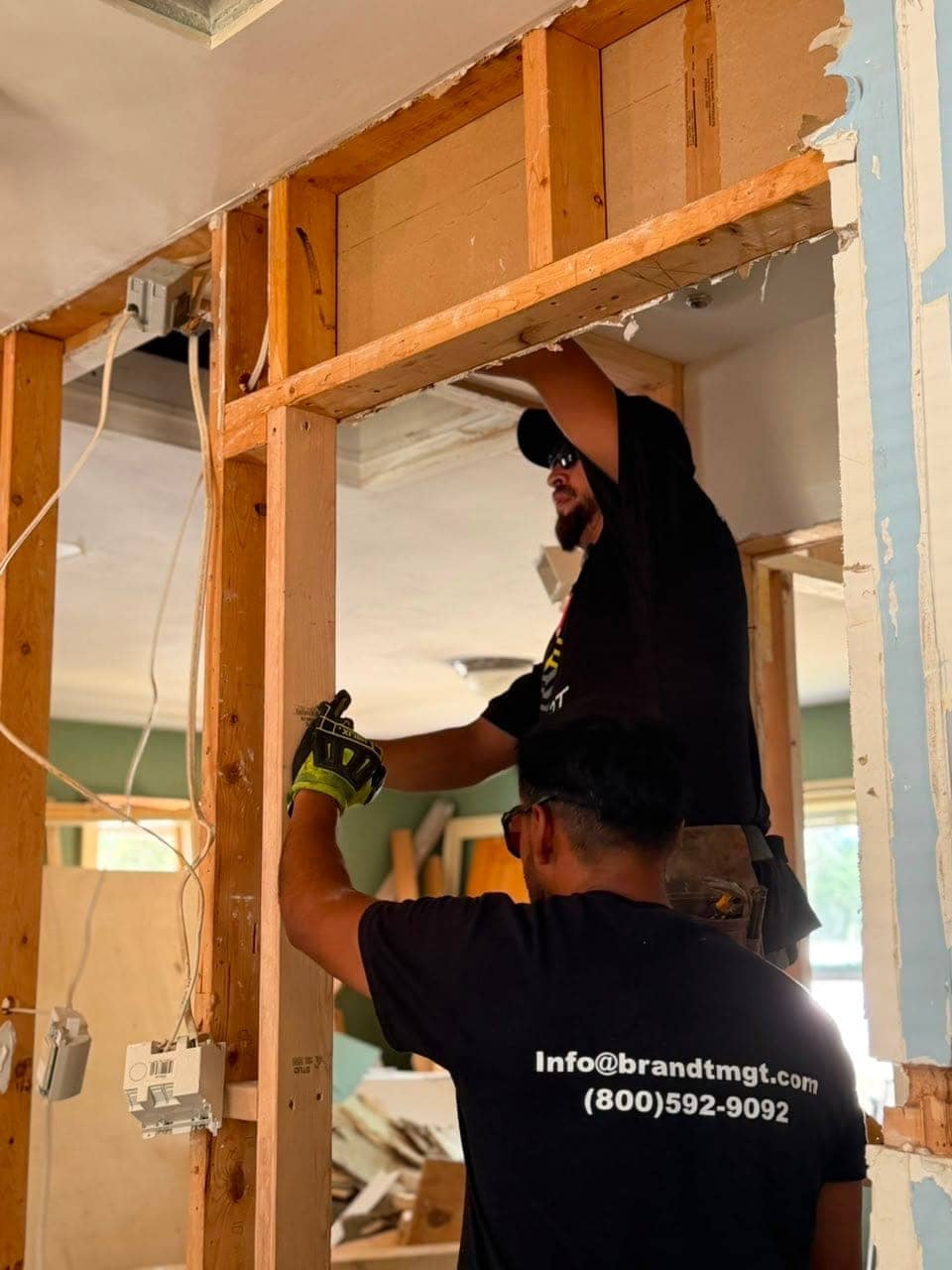 Two workers framing a doorway